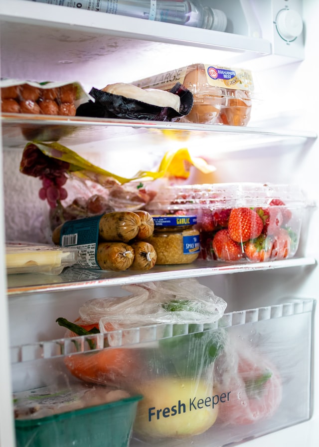 Picture of fresh cheese, fruit and vegetables in refrigerator with best used by dates. 