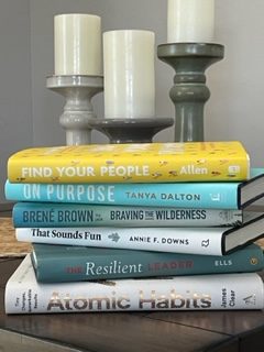 Stack of books with titles relating to procrastination, habits and self improvement.