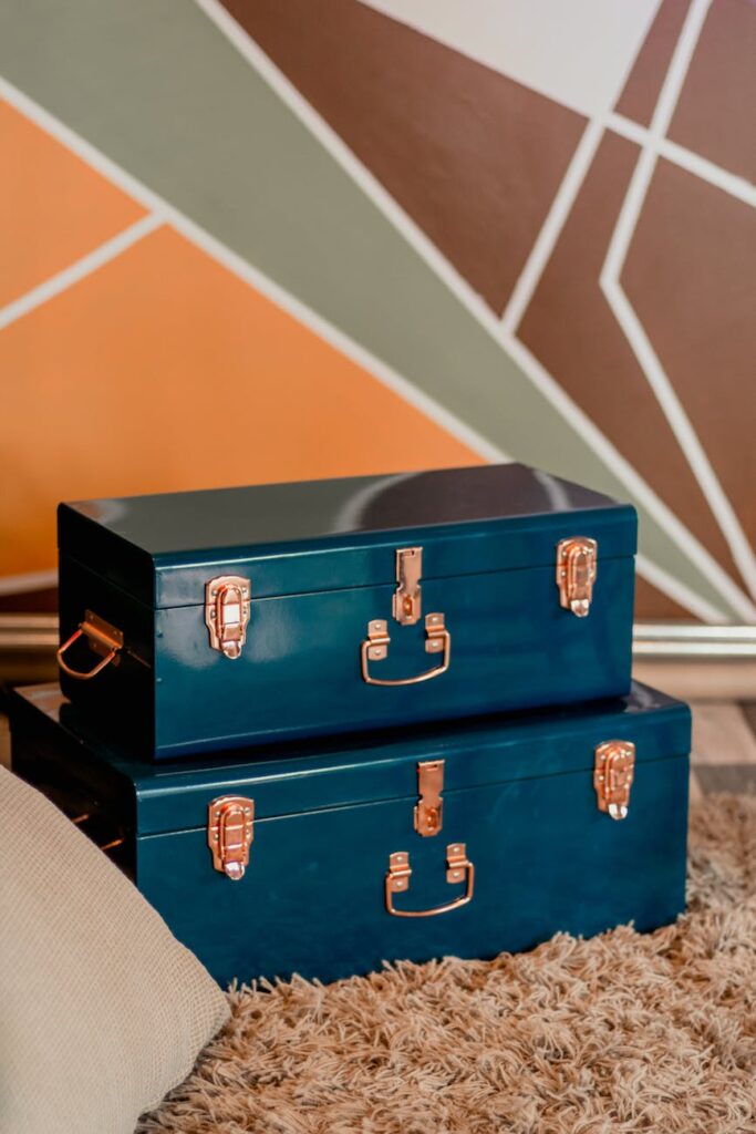 Two blue metal storage boxes symbolize excess baggage.