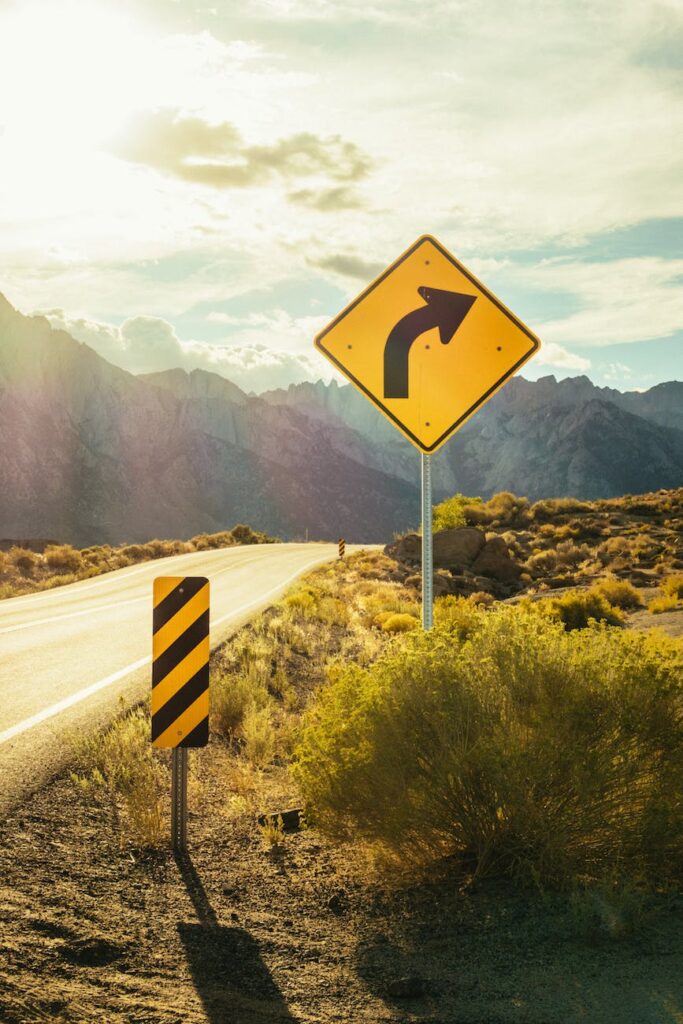 Road sign with caution right curve ahead signifies the need to watch for life curves such as sudden changes.